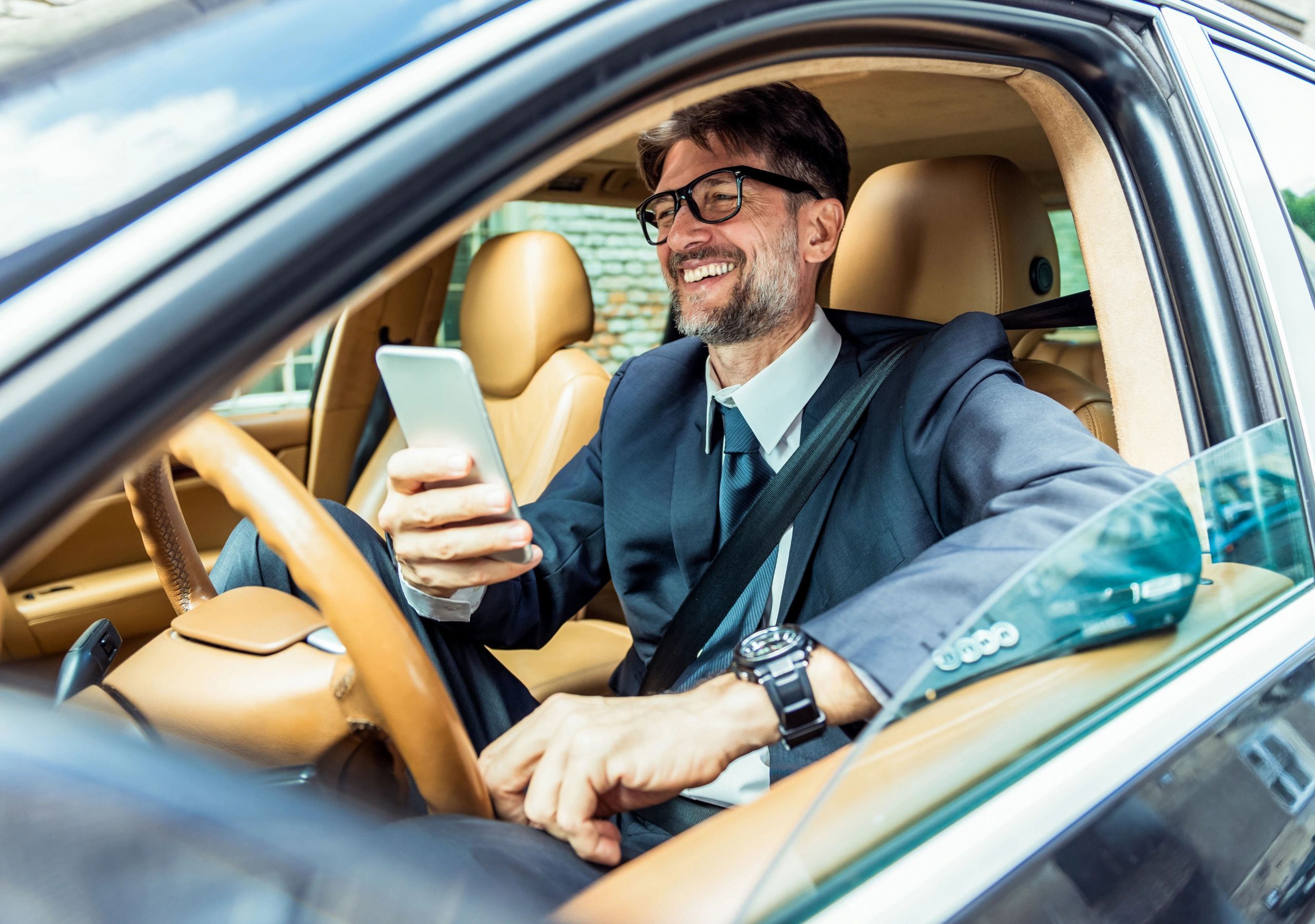 Person using a smartphone in a car