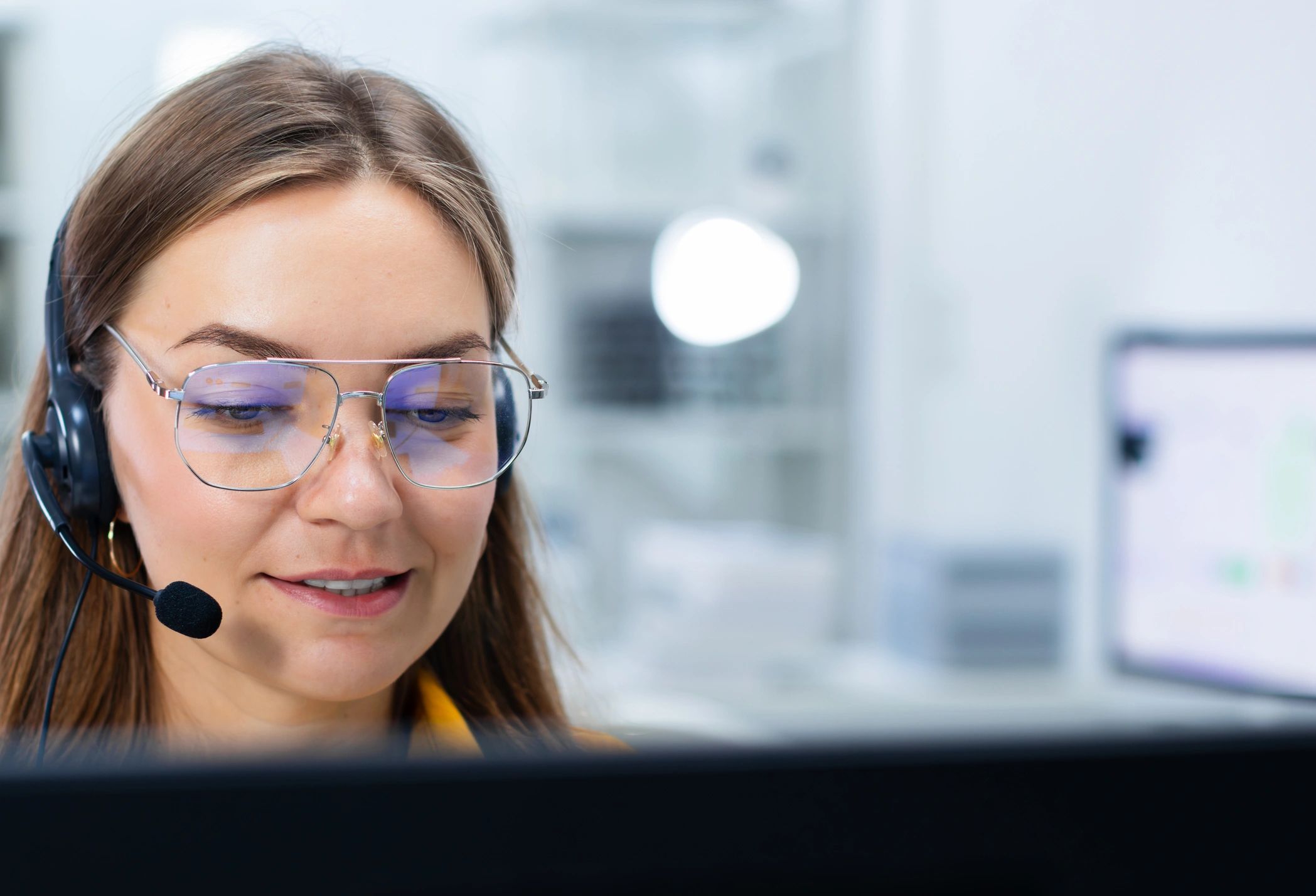 Customer service agent wearing a headset assisting a caller